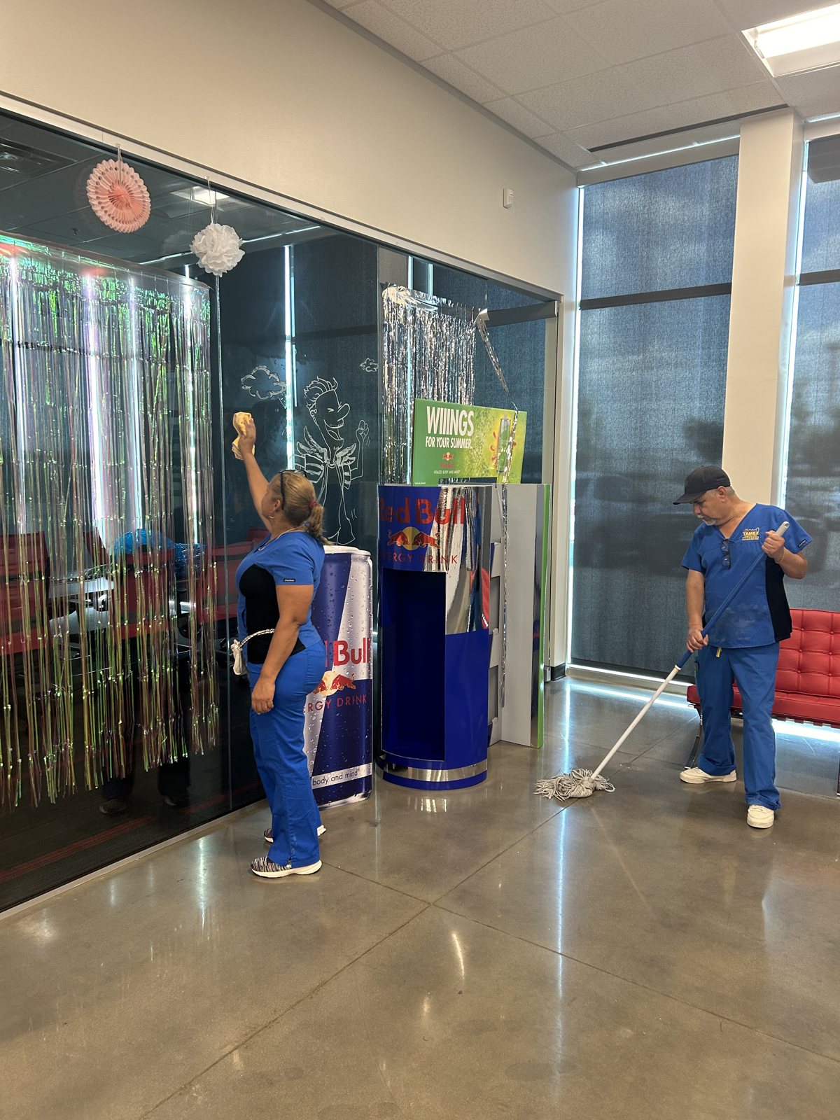 Tamez crew cleaning glass and floors in a client lobby