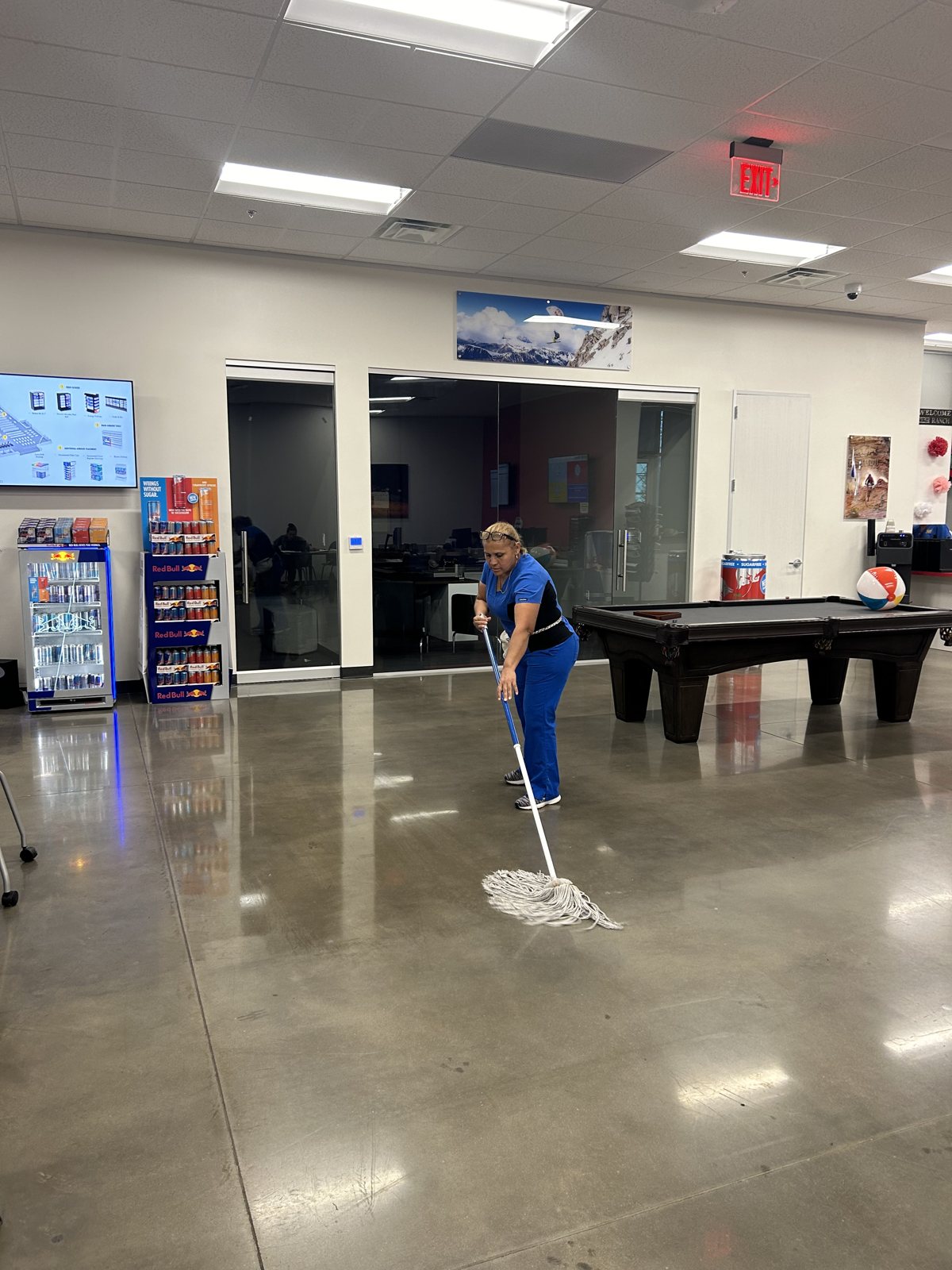 Tamez crew member mopping a break room floor